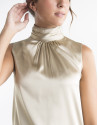 Sandy-colored top with high collar