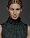 English green top with high draped collar