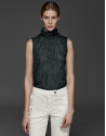 English green top with high draped collar