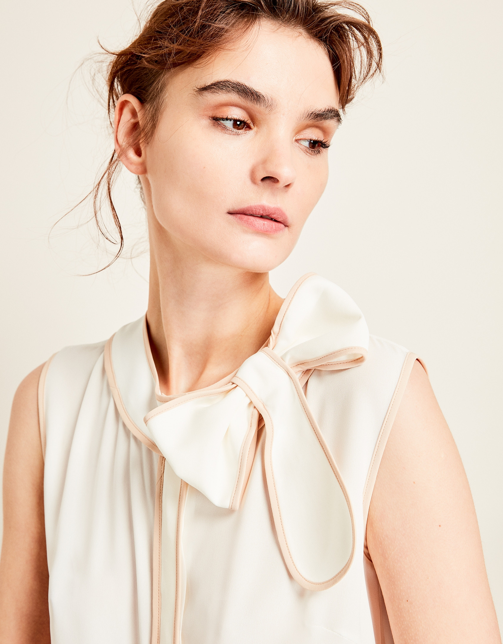 Beige top with bow