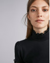 Black short-sleeved top with stovepipe collar