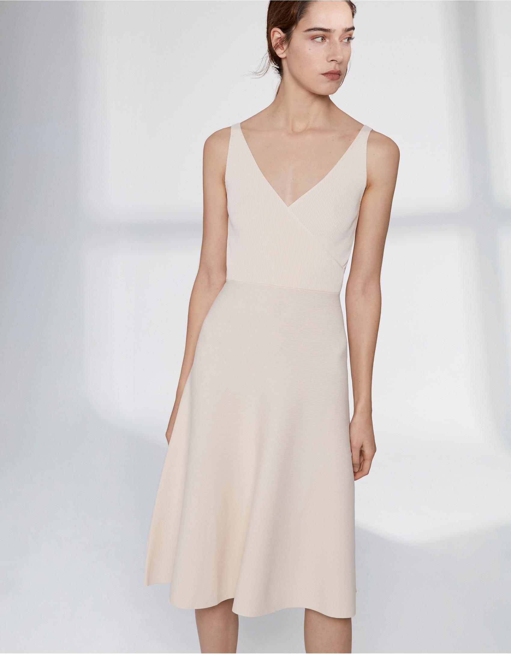 Sandy-colored knit dress with crossover neckline