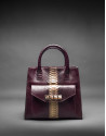 Burgundy leather Rocío Andrómeda bag with embossed snake and  old gold stripe