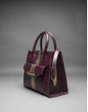 Burgundy leather Rocío Andrómeda bag with embossed snake and  old gold stripe
