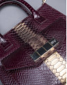 Burgundy leather Rocío Andrómeda bag with embossed snake and  old gold stripe