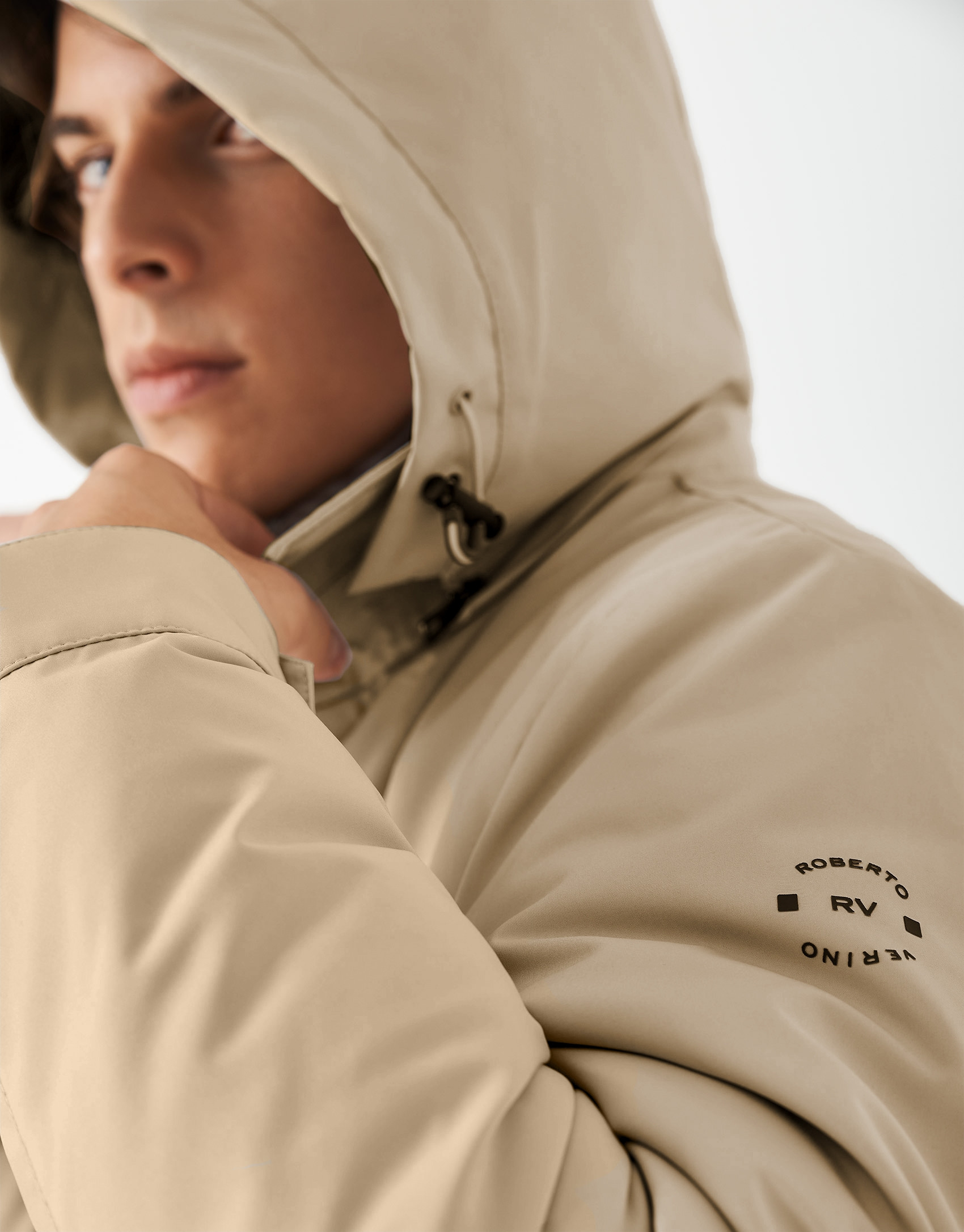 Sandy-colored minimal gabardine with brown windbreaker