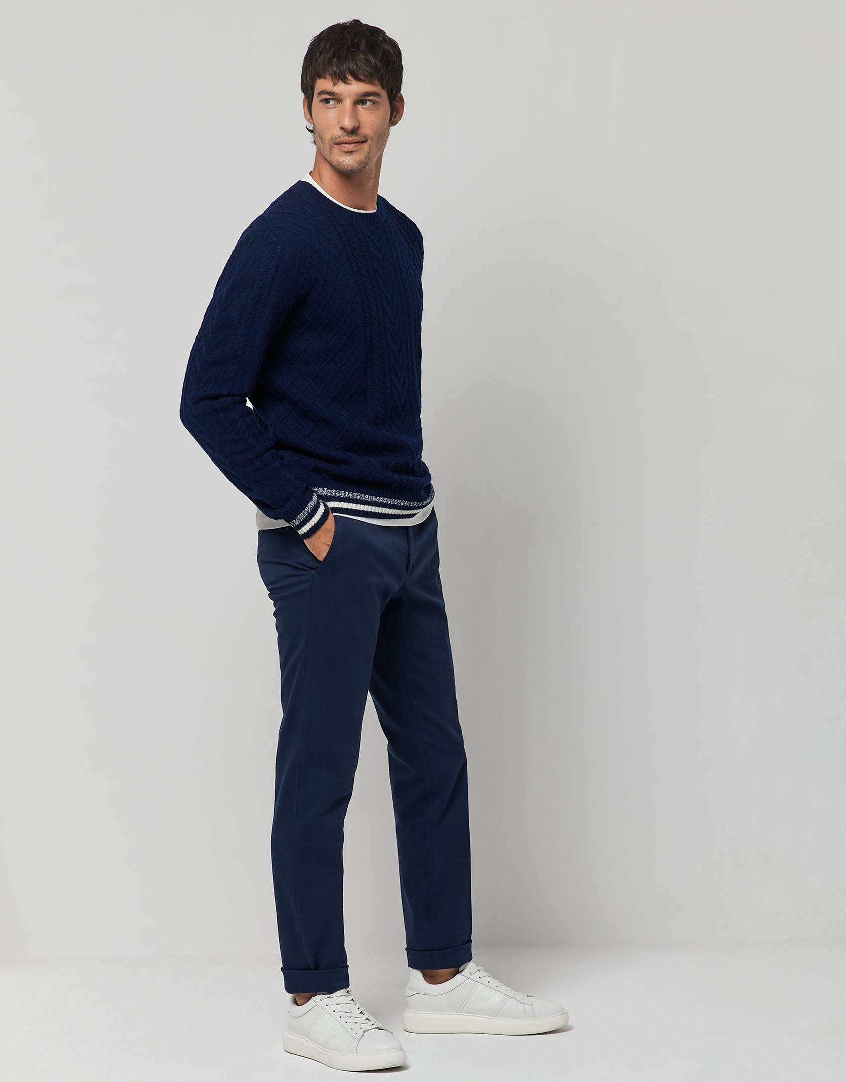 Blue cable-knit wool sweater with stripes on the cuffs