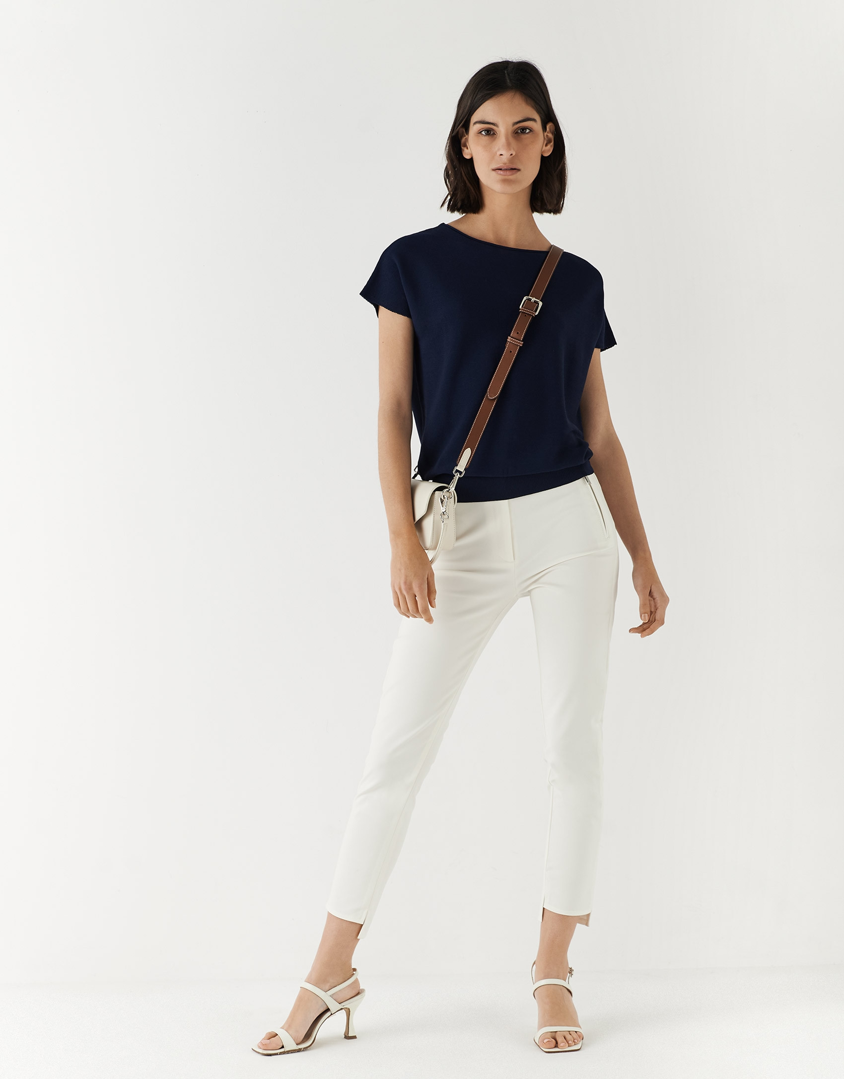 Beige colored fitted pants with zippered pockets