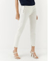 Beige colored fitted pants with zippered pockets