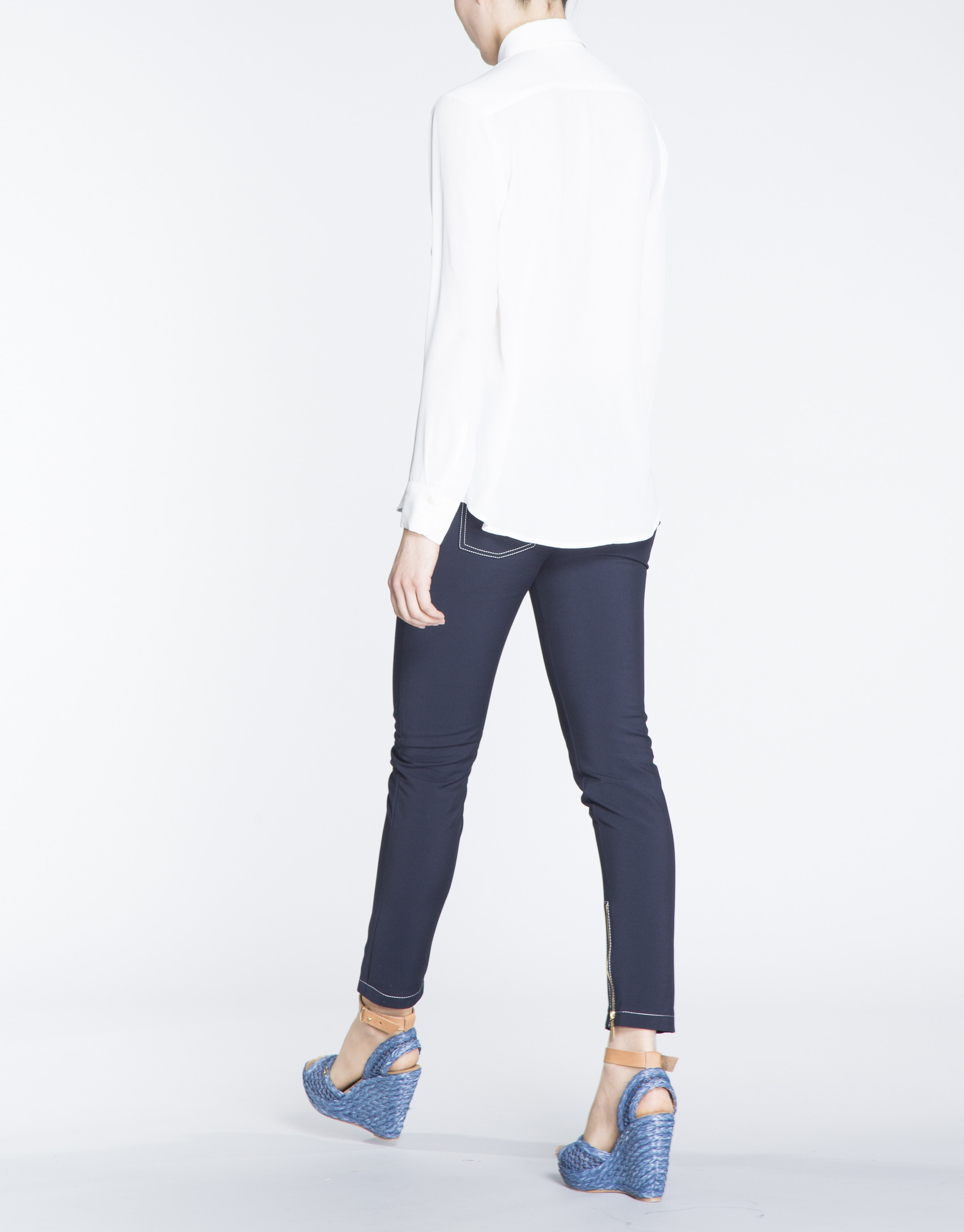 Camisa blanca de manga larga con bolsillos en delantero.