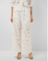 White devoré palazzo trousers with floral print | Roberto Verino