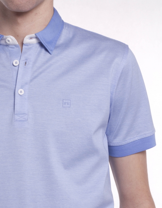 Blue pinstriped polo shirt, contrasting collar and ribbing on cuffs. Contrasting border on collar and interior half moon. 
