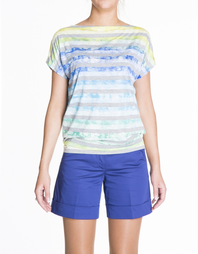 Loose gray striped top over blue, yellow and green print.