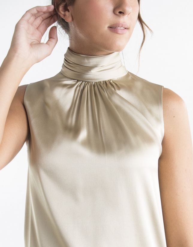Sandy-colored top with high collar