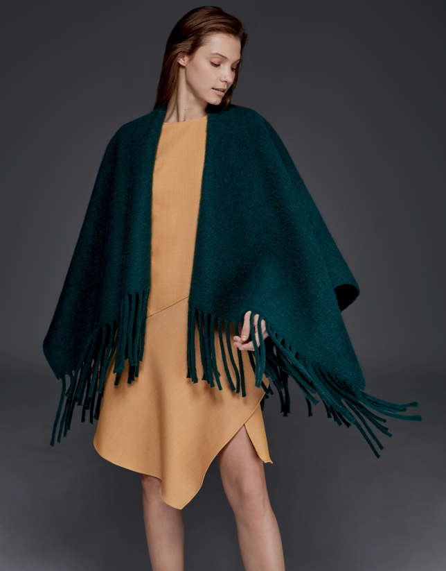 Green poncho with fringe
