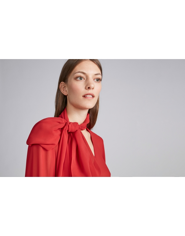 Poppy-colored flowing shirt with tie collar