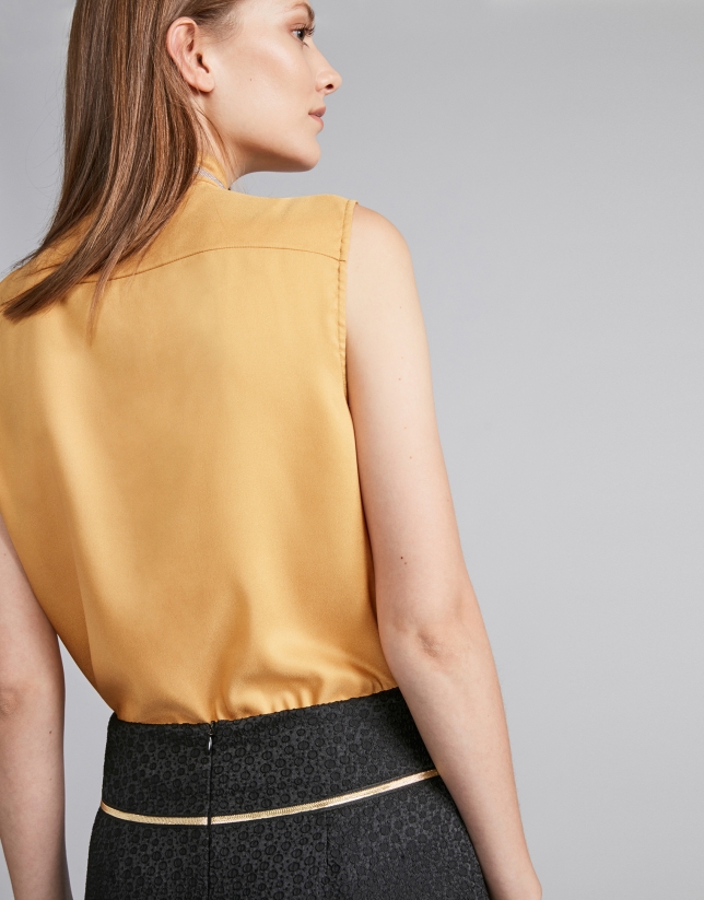 Gold-colored top with decorative collar