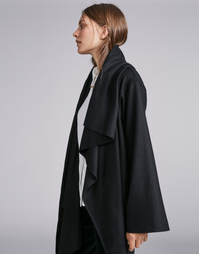 Black cape-effect jacket with fringe