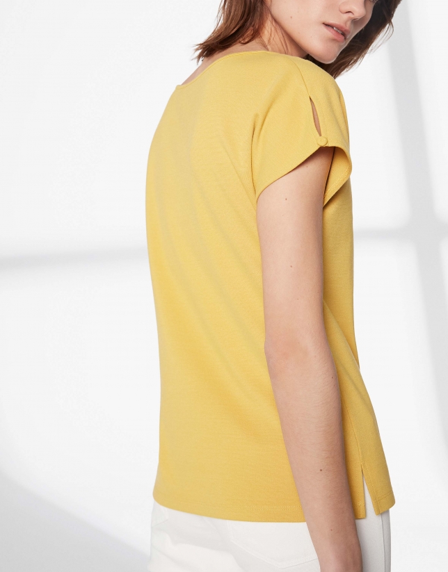 Mustard top with trim on chest