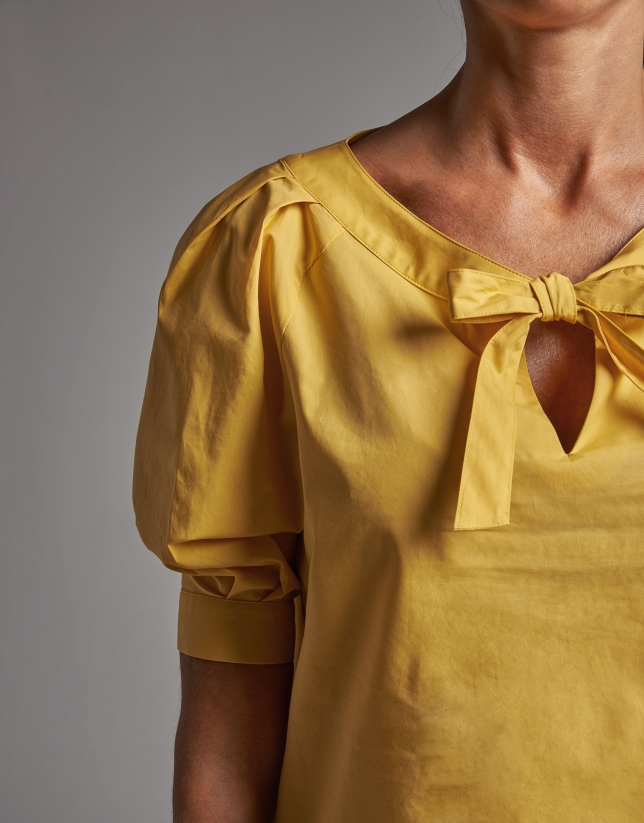 Yellow shirt with boat neck and bow