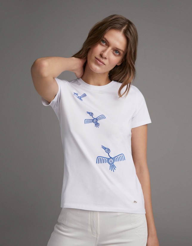 White top with embroidered blue birds
