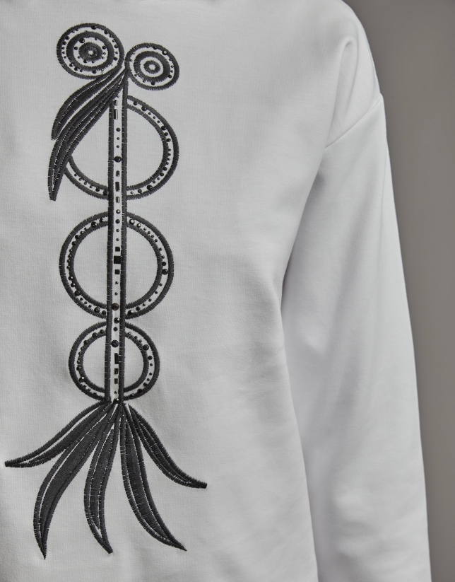 White sweatshirt with embroidered bird print and rhinestones