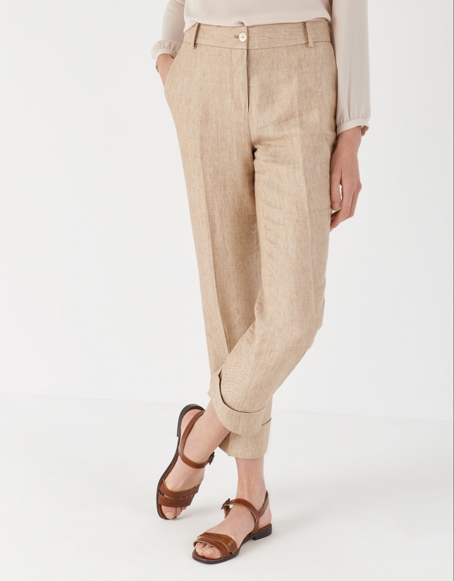 Sand-colored linen pants with turned up cuffs