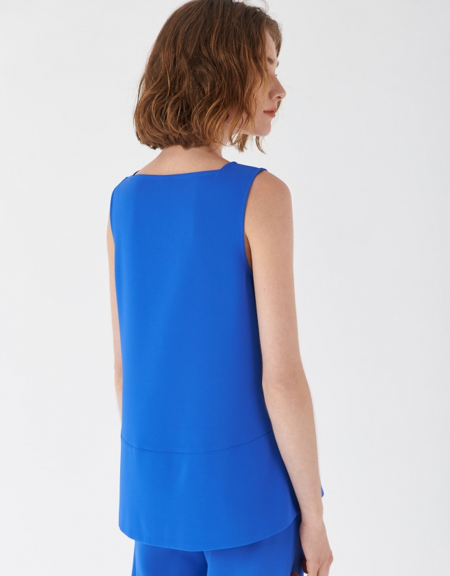 Blue sleeveless top with rounded hem