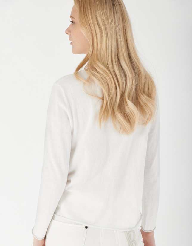 White top with long sleeves and decorative phrasing