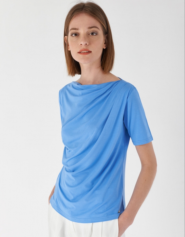 Blue top with draping at waist
