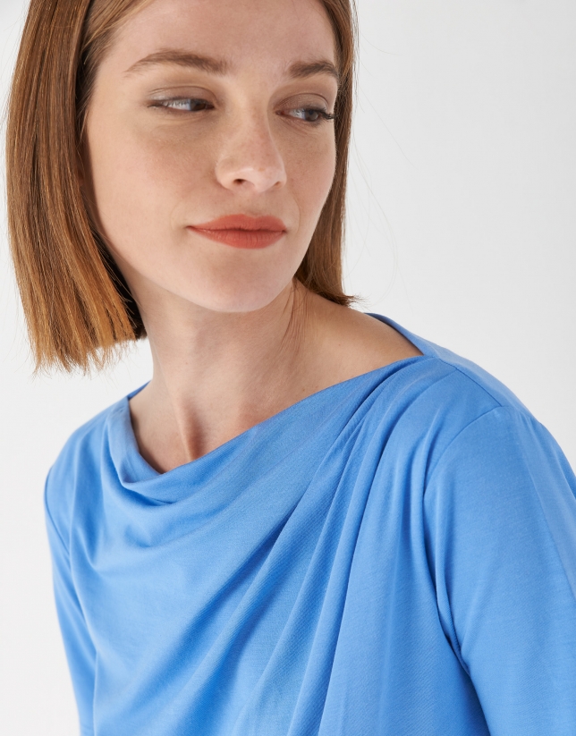 Blue top with draping at waist