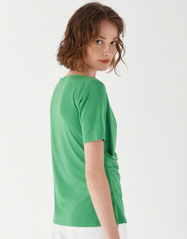 Green top with draping at waist