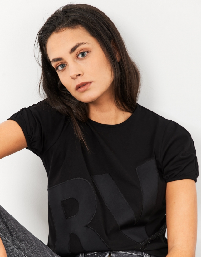 Black top with short sleeves and embroidered logo