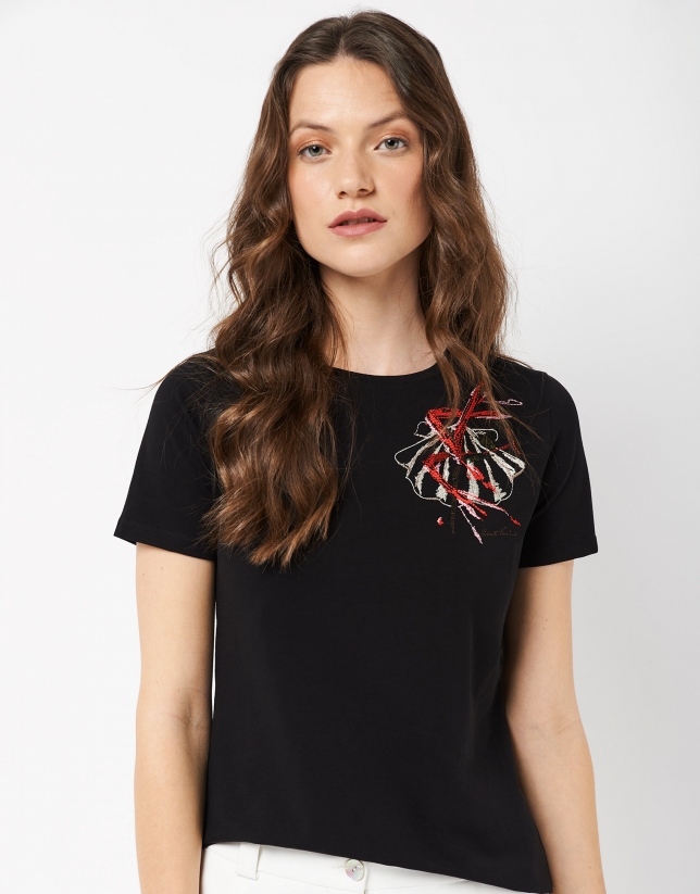 Black top with an embroidered flower on the chest