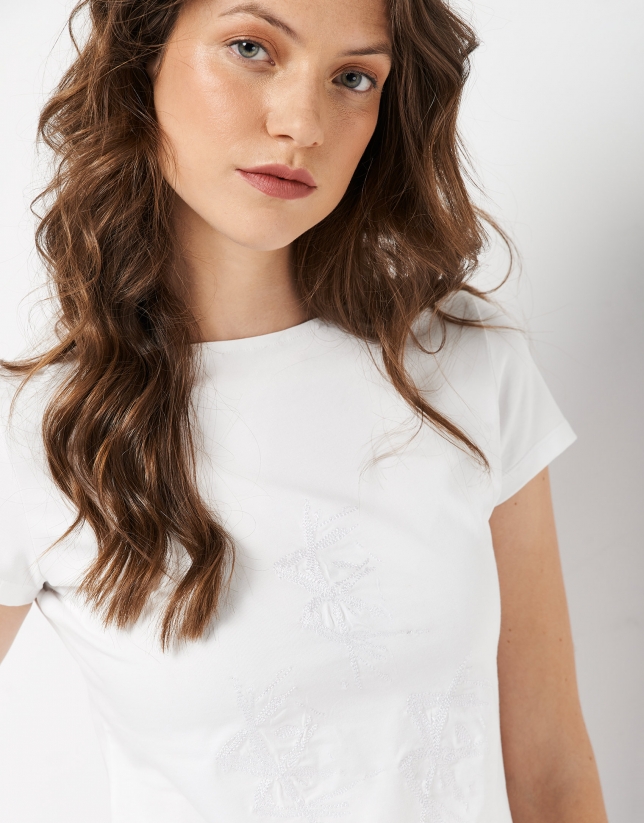 White top with three matching embroidered flowers