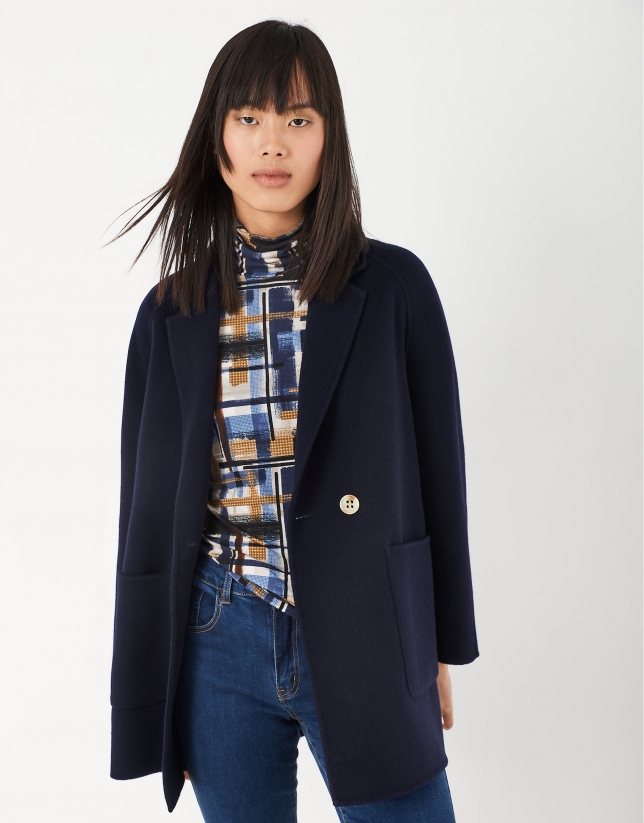 Short navy blue coat with double row of buttons