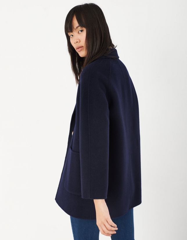 Short navy blue coat with double row of buttons