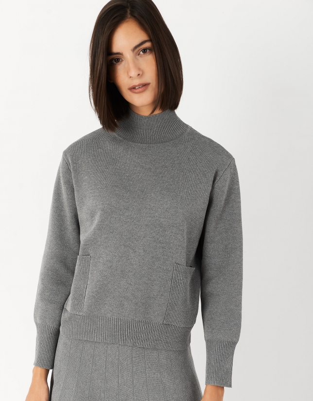 Gray sweater with raised collar and pockets