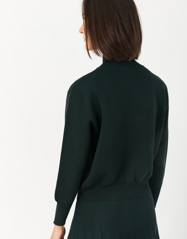 Green sweater with raised collar and pockets