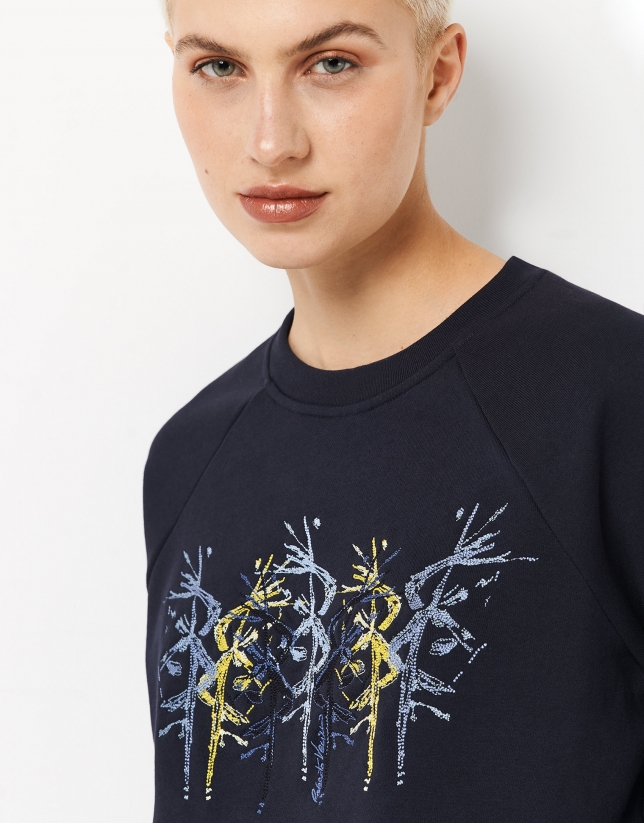 Navy blue sweatshirt with embroidered flower in the front