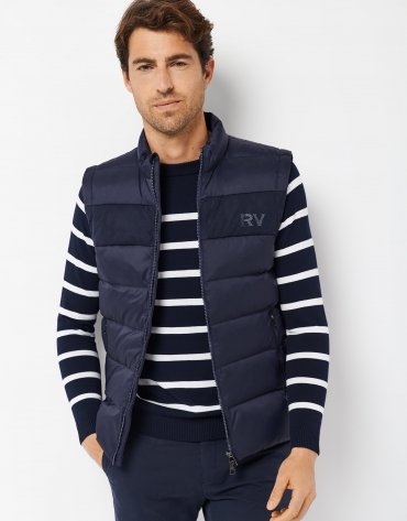 Navy blue quilted vest with RV logo on the chest