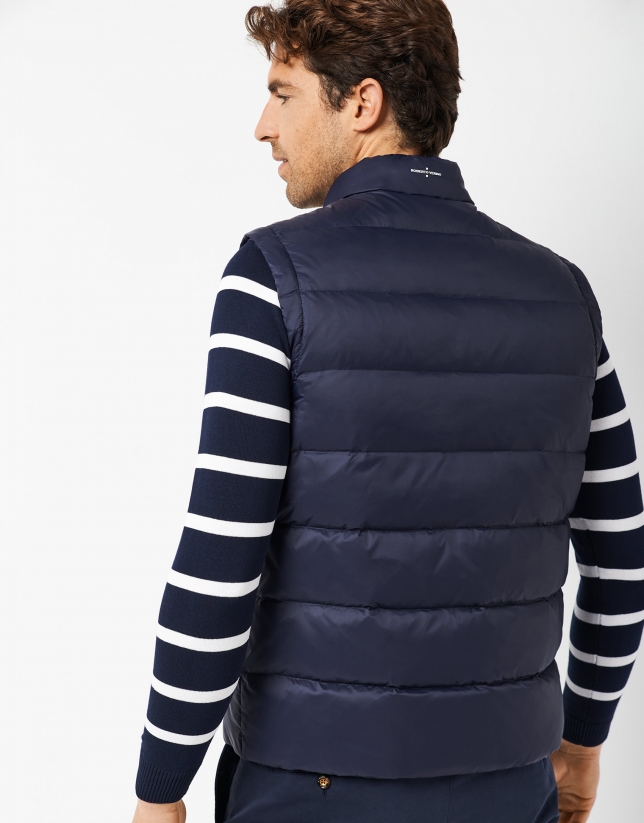 Navy blue quilted vest with RV logo on the chest