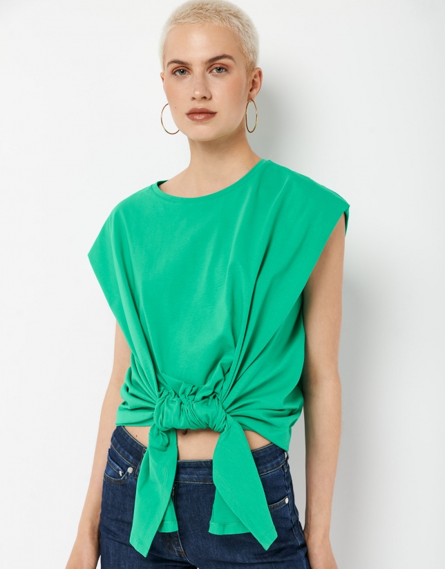 Green top with puckering and knotting in the front.