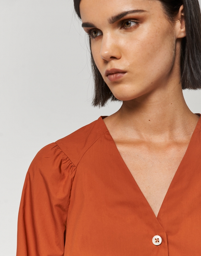 Orange blouse with V-neck and bow