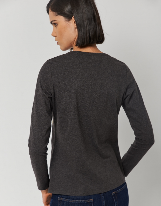 Black top with V-neck and embroidered design