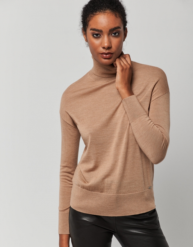 Beige fine knit sweater with turtleneck.