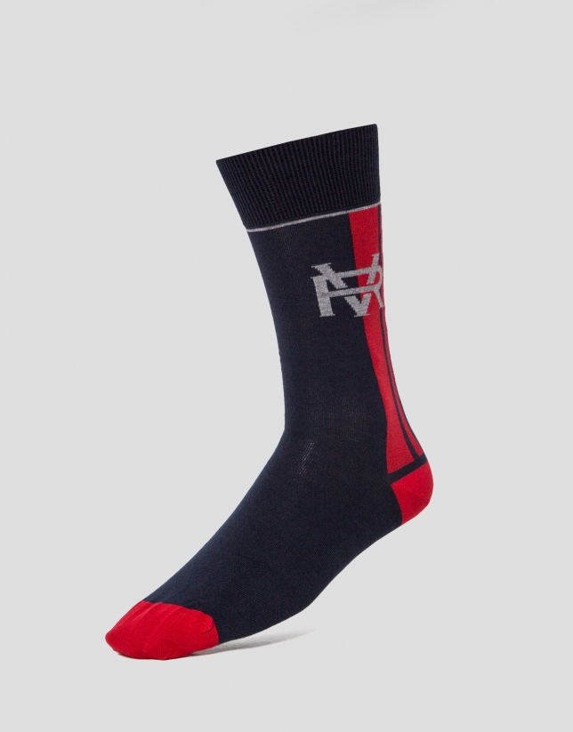 Two pairs of socks, one with a navy blue RV logo design and the other with gray circles