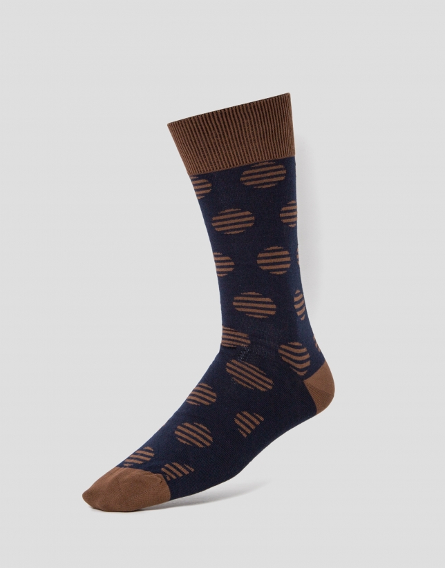Two pairs of socks, one with a navy blue and white design and the other with a blue and camel design 