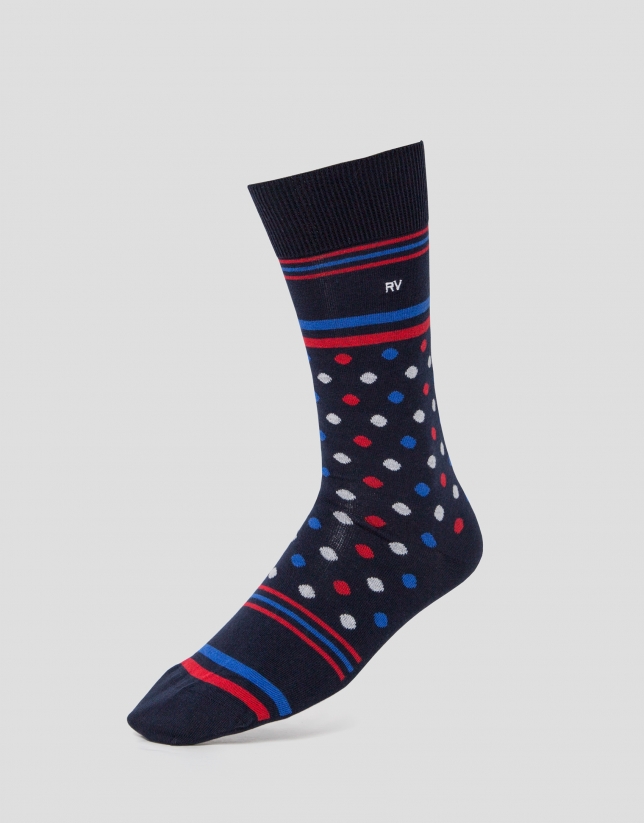 Two pairs of socks, one with navy blue dots and the other with a blue automobile print. 
