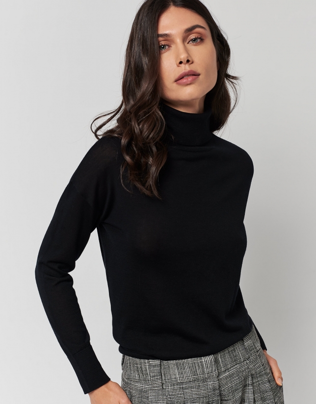 Black fine knit sweater with turtleneck.
